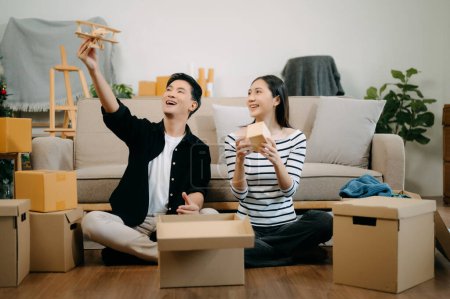 Photo for Asian young attractive couple man and woman in new house. Young married asian moving home. - Royalty Free Image