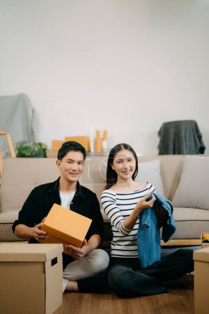 Foto de Asiático joven atractiva pareja hombre y mujer en nueva casa. joven casado asiático mudanza casa. - Imagen libre de derechos
