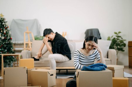 Photo for Divorce. Asian couples are desperate and disappointed after marriage. Husband and wife are sad, upset and frustrated after quarrels. family problem, teenage love. on sofa at home - Royalty Free Image