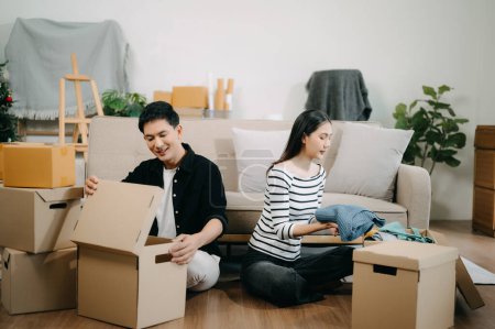 Photo for Asian young attractive couple man and woman in new house. Young married asian moving home. - Royalty Free Image