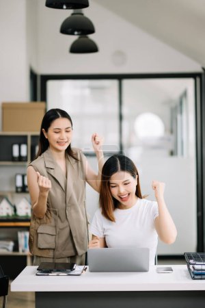 Photo for Two Asian businesswomen  discuss investment project working and planning strategy in modern office. - Royalty Free Image