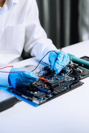 Photo for The technician is putting the CPU on the socket of the computer motherboard. electronic engineering electronic repair, electronics measuring and testing, repair in office - Royalty Free Image