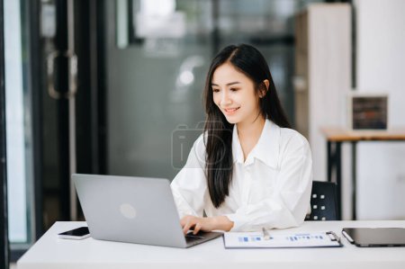 Photo for Beautiful Asian business woman working on laptop, Placed at the table at the office - Royalty Free Image