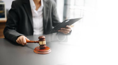 Photo for Justice and law concept. Female judge in a courtroom on wooden table working in office - Royalty Free Image