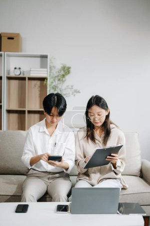 Photo for Portrait of success young business people working together on sofa in modern office. Couple teamwork startup concept - Royalty Free Image