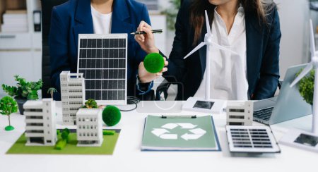 Téléchargez les photos : Planification de l'équipe d'affaires et discussion sur les énergies alternatives avec le symbole de recyclage dans la salle de réunion du bureau. Entreprise verte et énergie solaire Environnement Concept - en image libre de droit