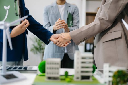 Photo for Business team shaking hands on recycle symbol in office meeting room. Green business company and Solar Energy Environment city Concept - Royalty Free Image