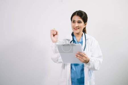 Photo for Muslim Arab person. The face of a female doctor holding clipboard in the hands on an isolated white background in studio - Royalty Free Image
