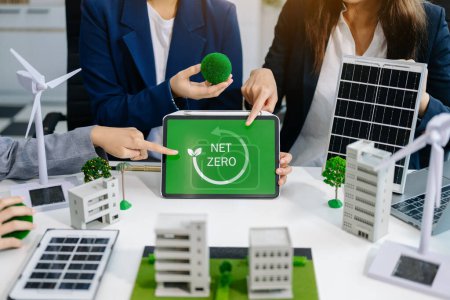 Photo for Business team planning using tablet for working technology and business Net zero and carbon neutral concept. NET ZERO icon and symbol save the eco world and reduce pollution, green energy - Royalty Free Image