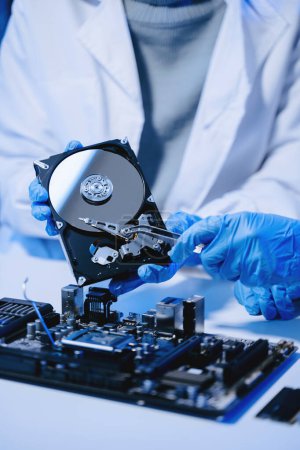Photo for Technicians repairing inside of hard disk drive - Royalty Free Image