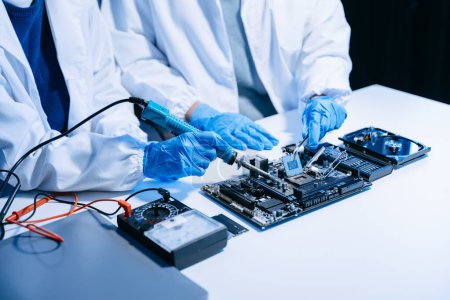 Photo for The technicians is putting the CPU on the socket of the computer motherboard - Royalty Free Image