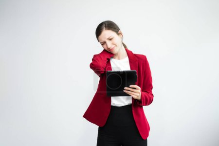 Photo for Disappointed businesswoman standing on white background and using digital tablet - Royalty Free Image