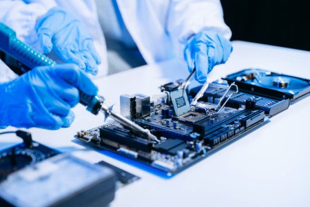 Photo for The technicians is putting the CPU on the socket of the computer motherboard. electronic engineering electronic repair, electronics measuring and testing - Royalty Free Image