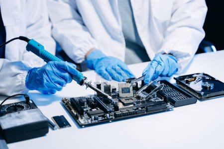 Photo for The technicians is putting the CPU on the socket of the computer motherboard. electronic engineering electronic repair, electronics measuring and testing - Royalty Free Image