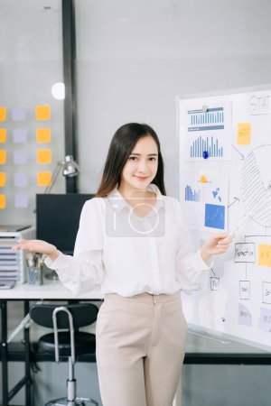 Photo for Young beautiful woman standing board with business plan at in office - Royalty Free Image