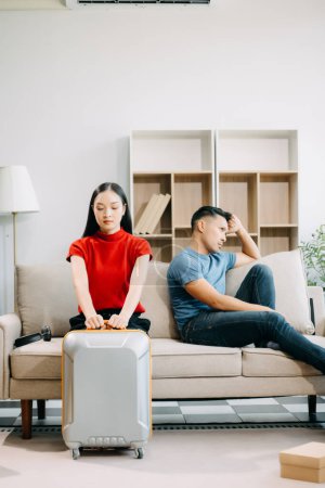 Divorce concept. Asian couple are desperate and disappointed after marriage at home. Husband and wife are sad, upset and frustrated after quarrels 