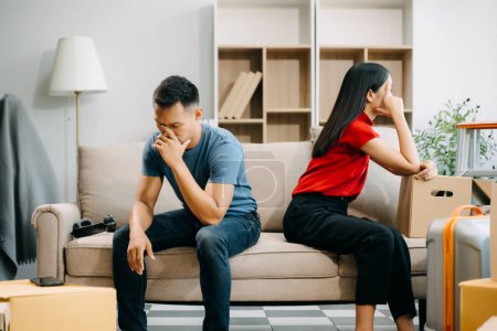 Divorce concept. Asian couple are desperate and disappointed after marriage at home. Husband and wife are sad, upset and frustrated after quarrels 