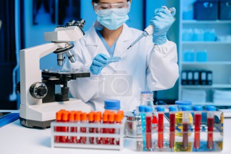 Photo for Modern medical research laboratory. female scientist working with micro pipettes analyzing biochemical samples, advanced science chemical laboratory - Royalty Free Image