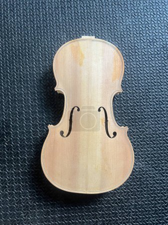 Raw violin made from wood put on background,show detail of acoustic instrument