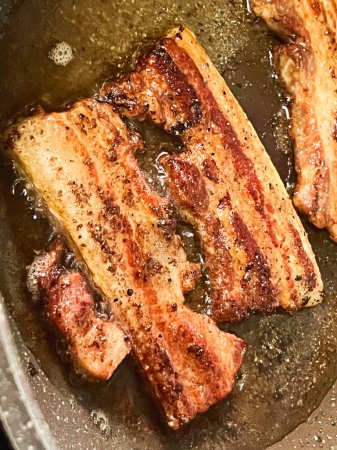 Fried pork belly in a pan.mixed Red meat and lean meat per each.delicious food for eat