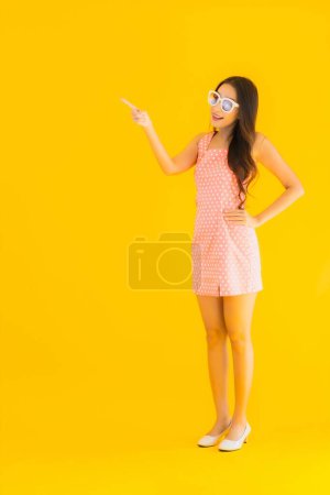 Photo for Portrait beautiful young asian woman smile happy on yellow isolated background - Royalty Free Image