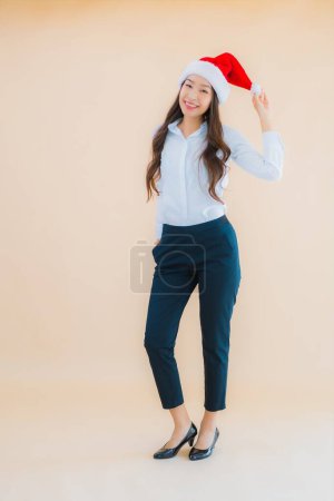 Photo for Portrait beautiful young business asian woman wear christmas hat on color isolated background - Royalty Free Image