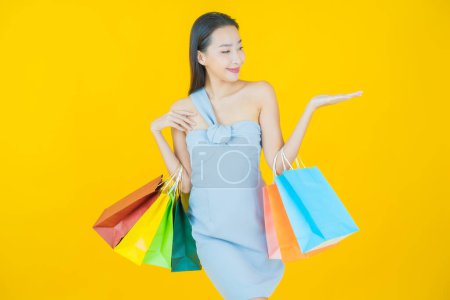 Photo for Portrait beautiful young asian woman smile with shopping bag on color background - Royalty Free Image