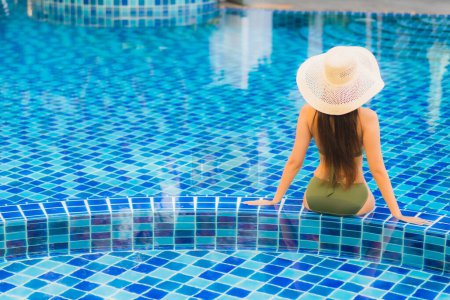 Photo for Portrait beautiful young asian woman relax around swimming pool in hotel resort for leisure in vacation - Royalty Free Image