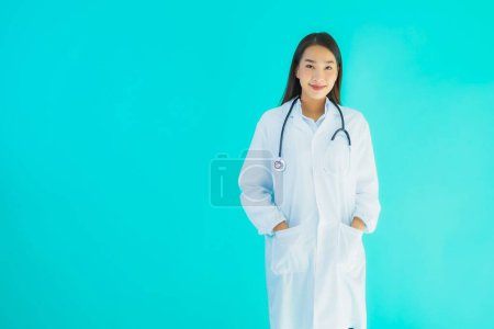 Photo for Portrait beautiful young asian doctor woman with stethoscope for use in clinic or hospital on blue isolated background - Royalty Free Image