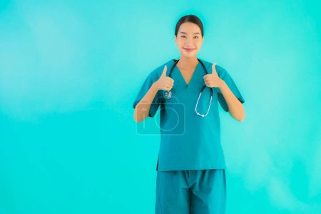 Photo for Portrait beautiful young asian doctor woman happy smile for work in hospital and clinic on blue isolated background - Royalty Free Image