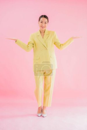 Foto de Retrato hermosa joven asiática mujer de negocios sonrisa en acción sobre rosa color de fondo - Imagen libre de derechos