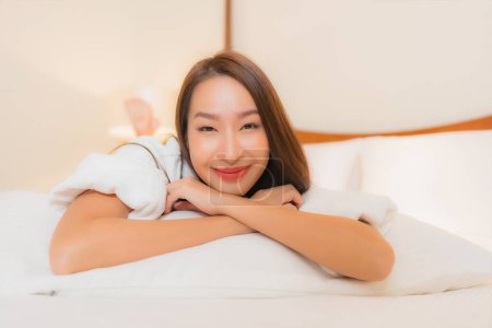 Photo for Portrait beautiful young asian woman smile relax leisure on bed in bedroom interior - Royalty Free Image