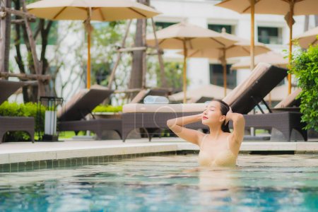 Photo for Portrait beautiful young asian woman relax smile around outdoor swimming pool in hotel resort for travel vacation - Royalty Free Image