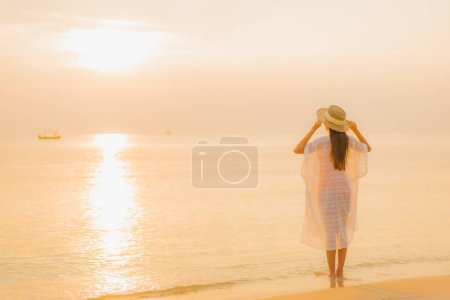Photo for Portrait beautiful young asian woman relax smile leisure around outdoor sea beach ocean at sunset time for vacation - Royalty Free Image
