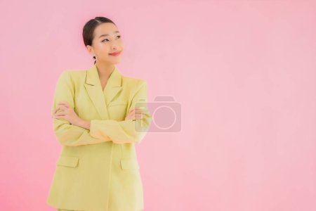 Photo for Portrait beautiful young asian business woman smile in action on pink color background - Royalty Free Image