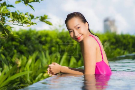 Photo for Portrait beautiful young asian woman relax enjoy around outdoor swimming pool in holiday vacation - Royalty Free Image