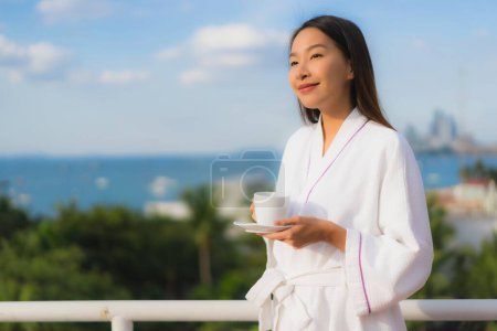 Photo for Portrait beautiful young asian women hold coffee cup in hand around nature outdoor view - Royalty Free Image