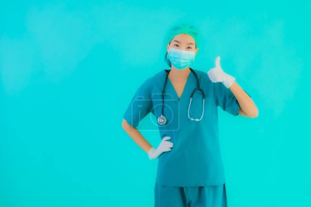 Photo for Portrait beautiful young asian doctor woman with mask and eyeglassses for protect from covid19 or coronavirus on blue isolated background - Royalty Free Image