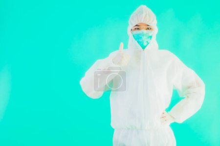 Photo for Portrait beautiful young asian doctor woman wear ppe or  personal protective equipment for protect from coronavirus or covid19 with empty card white board on blue isolated background - Royalty Free Image