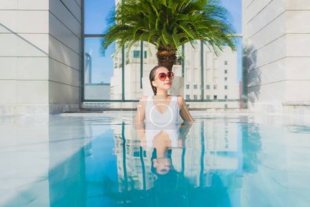 Photo for Portrait beautiful young asian woman relax leisure around swimming pool in vacation travel - Royalty Free Image