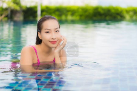 Photo for Portrait beautiful young asian woman relax enjoy around outdoor swimming pool in holiday vacation - Royalty Free Image