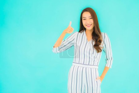 Photo for Portrait beautiful young asian woman smile in action on blue isolated background - Royalty Free Image
