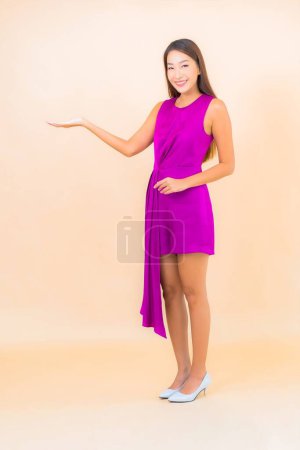 Photo for Portrait beautiful young asian woman in action on color isolated background - Royalty Free Image