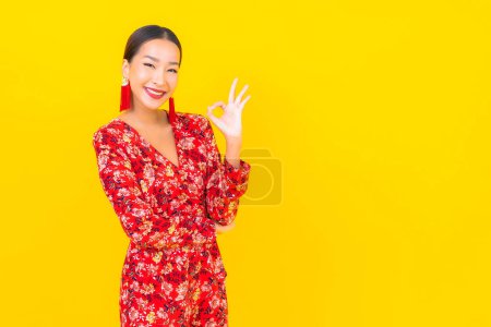 Photo for Portrait beautiful young asian woman smile in action in chinese new year concept on color background - Royalty Free Image