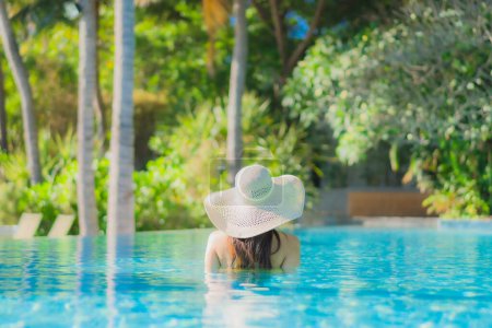 Photo for Portrait beautiful young asian woman happy smile relax around outdoor swimming pool in hotel resort for leisure travel vacation - Royalty Free Image
