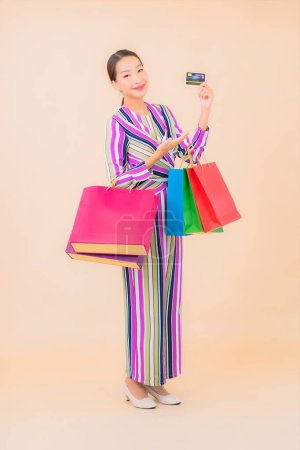 Photo for Portrait beautiful young asian woman with colorful shopping bag on color isolated background - Royalty Free Image