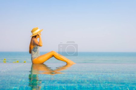 Photo for Portrait beautiful young asian woman relax smile enjoy leisure around swimming pool in resort hotel on vacation - Royalty Free Image