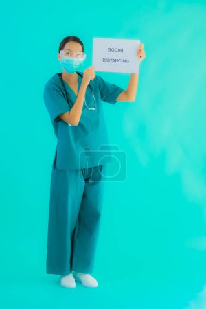 Photo for Portrait beautiful young asian doctor woman wear mask show Social distancing on paper board for protect from covid19 or coronavirus - Royalty Free Image
