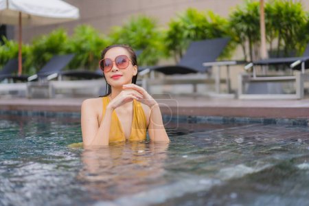 Photo for Portrait beautiful young asian woman relax leisure around swimming pool in hotel resort - Royalty Free Image