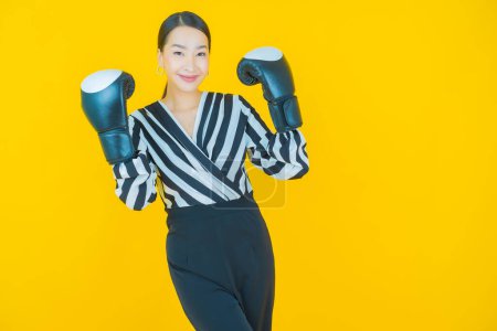 Photo for Portrait beautiful young asian woman with boxing glove on color background - Royalty Free Image
